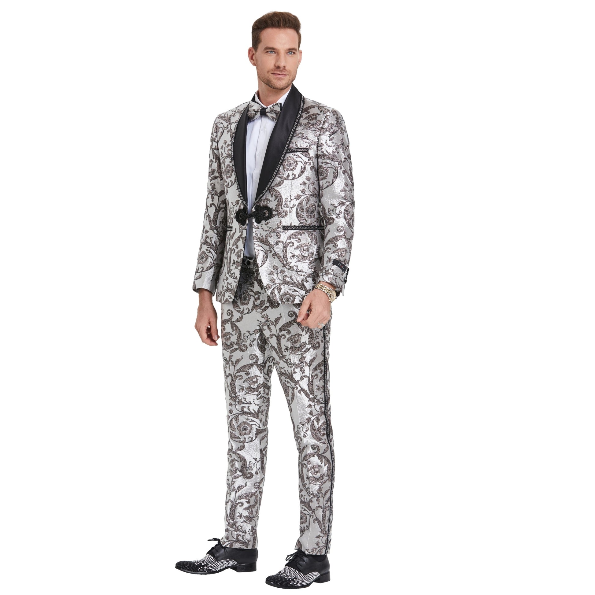 Shiny Silver Tuxedo with Black Paisley, Silver Paisley Design Pants, Black and Silver Lapel Detail, Shiny Silver Paisley Bowtie, Slim Fit Tuxedo Style.