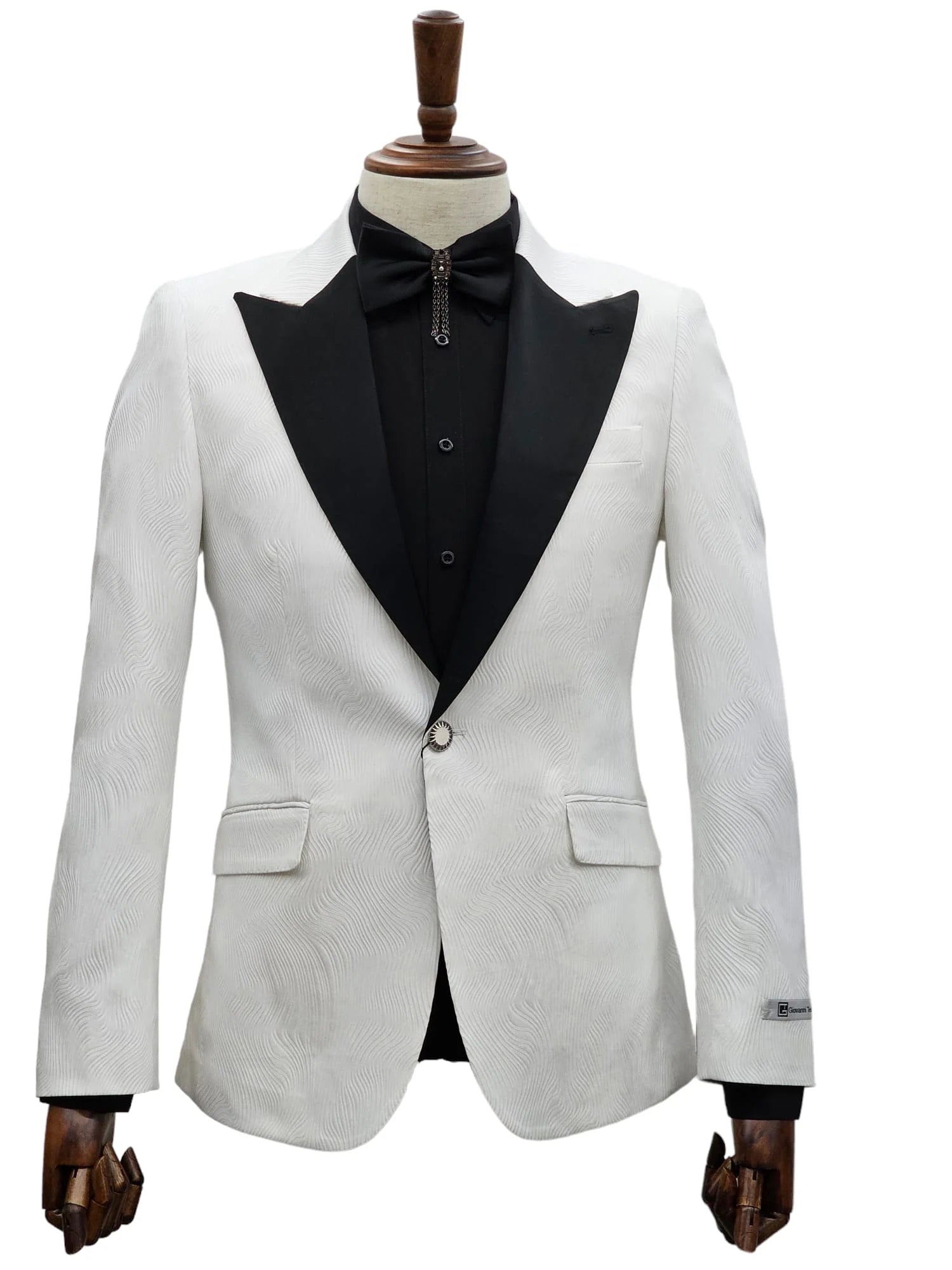 Elegant white tuxedo jacket with black trim and trousers on display."