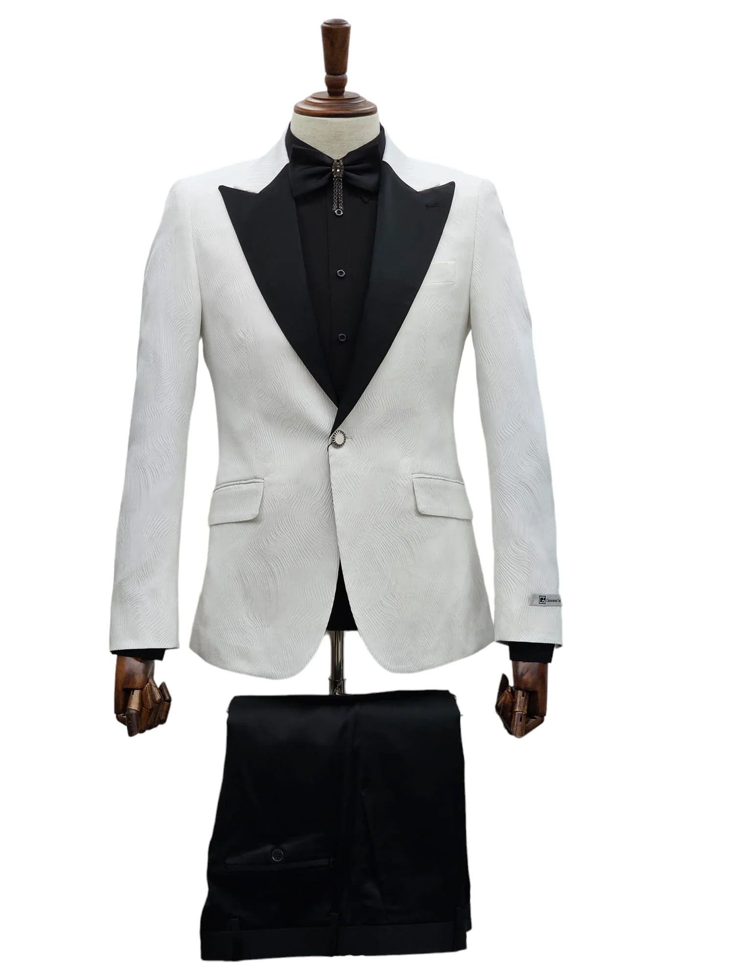 Elegant white tuxedo jacket with black trim and trousers on display."