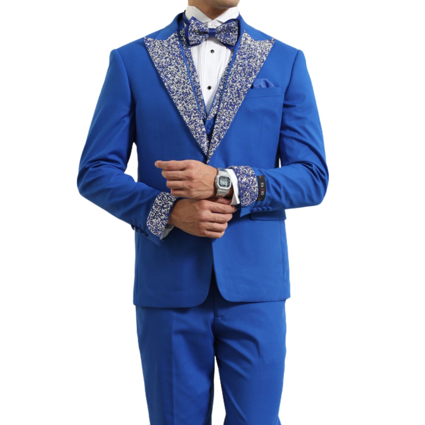 Men's royal blue sequin lapel three-piece tuxedo with matching vest and bowtie, featuring glittering sequin accents on the lapel and cuffs.