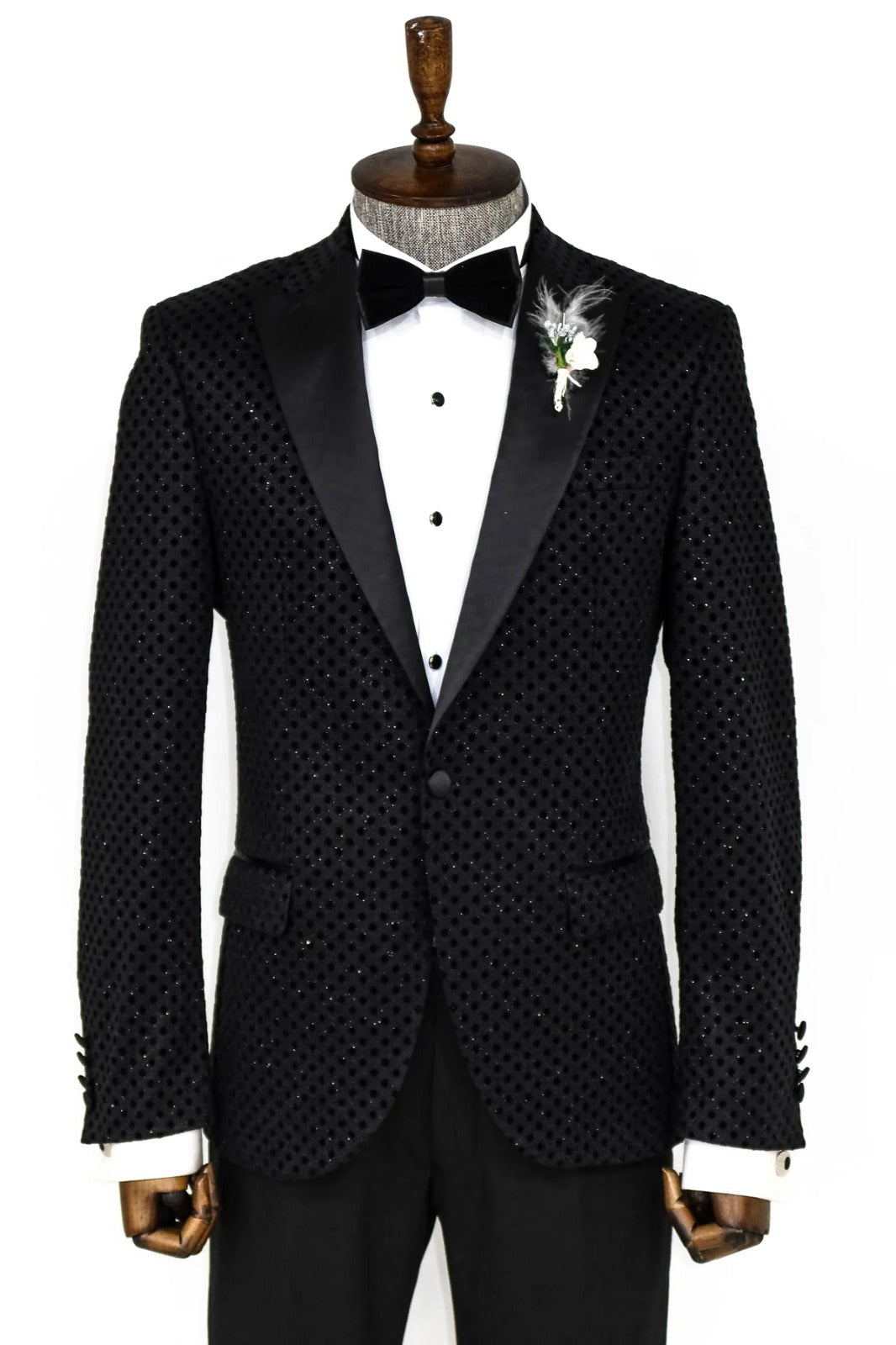 Man wearing a stylish Black Dot Sparkle Paisley Engraved Prom Blazer by KCT Menswear, showcasing elegance and sophistication in formal wear.