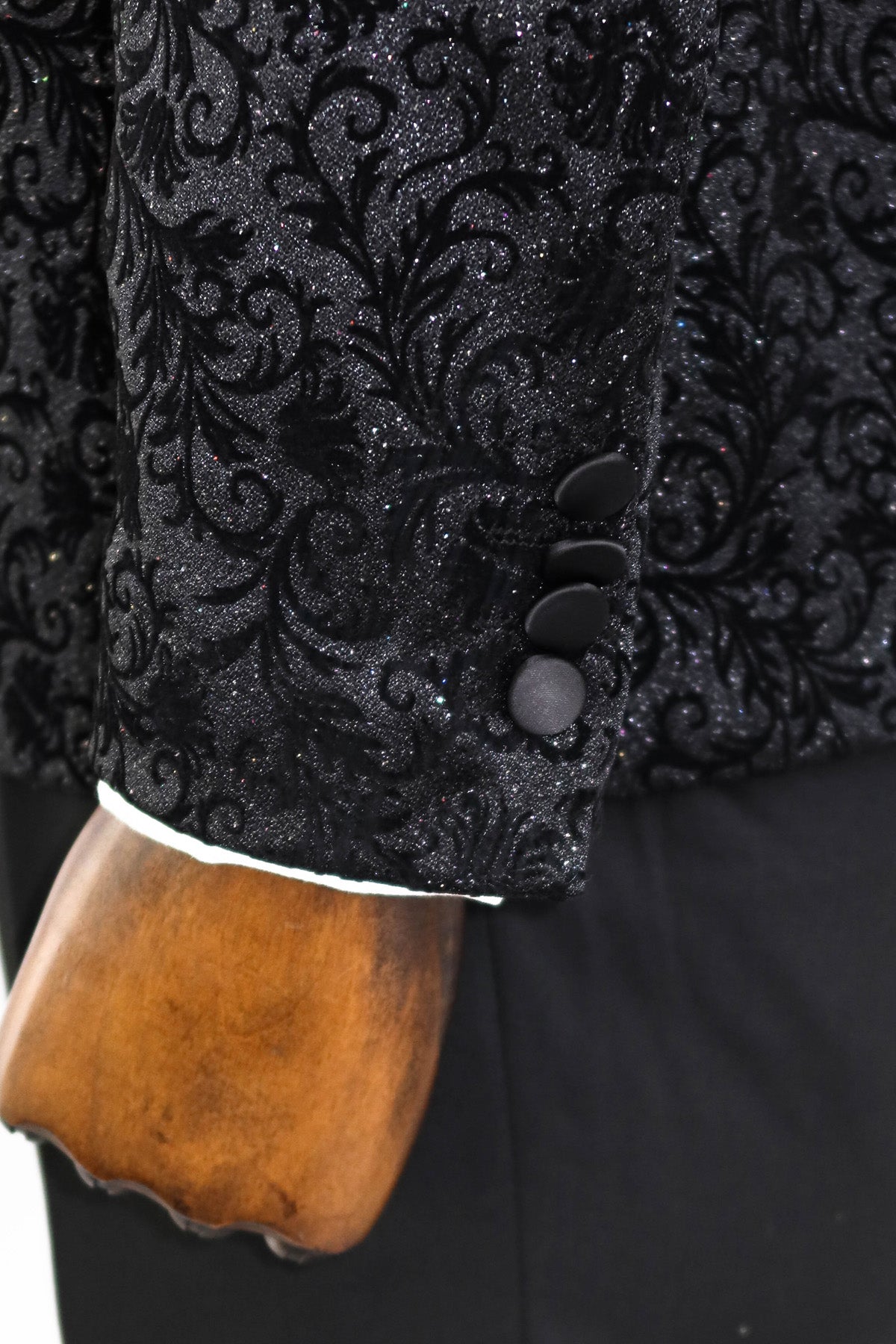 KCT Menswear Floral Sparkle Black Prom Blazer on hanger with floral sparkle black pattern